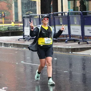 Mujer levantando sus dos brazos en 21k marathon