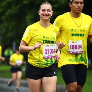 Grupo corriendo en asfalto mojado