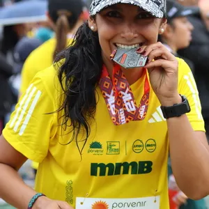 mujer feliz mordiendo medalla