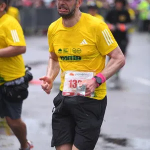 Participante corriendo con expresión de esfuerzo.