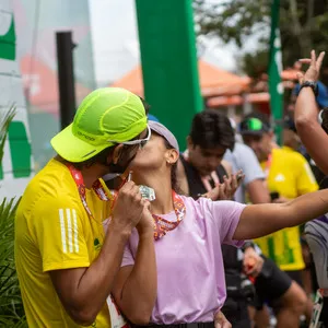 Beso de pareja con medalla de carrera